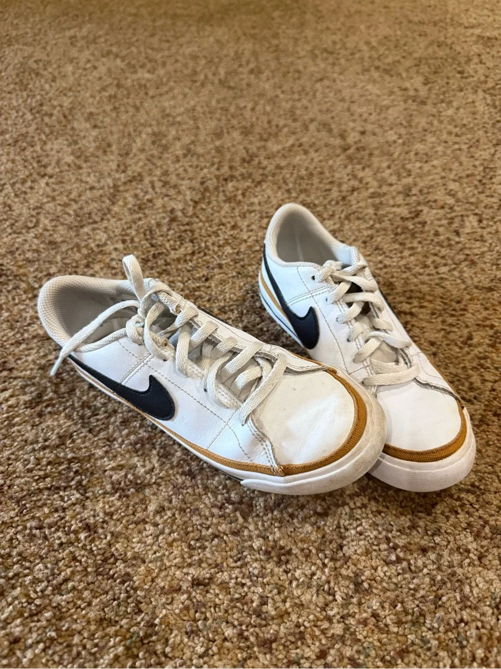 Nike White Sneakers with Black Swoosh and Brown Accent